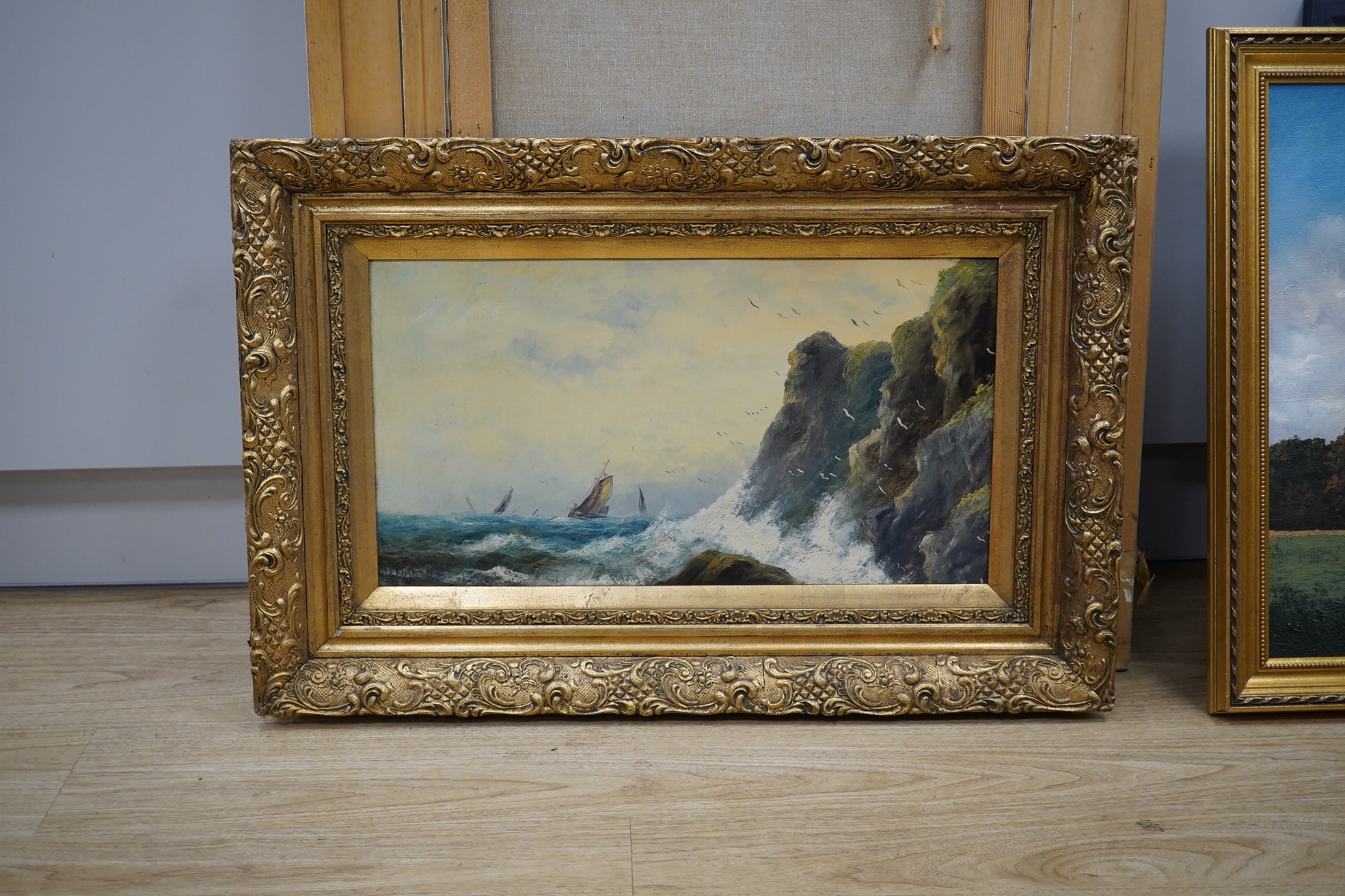 J. Ferguson, oil on board, Rocky seascape with boats, signed and indistinctly dated, 29 x 54cm, ornate gilt framed. Condition - fair to good